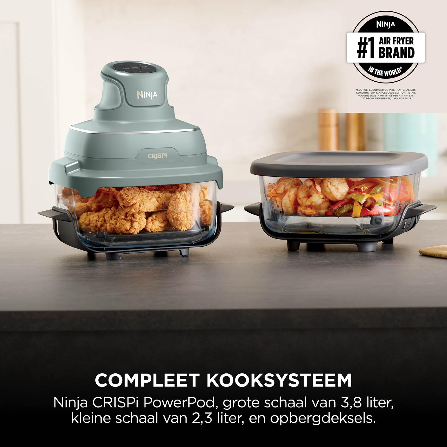 A mint green Ninja Crispi air fryer with glass containers holding fried chicken and shrimp on a kitchen counter.