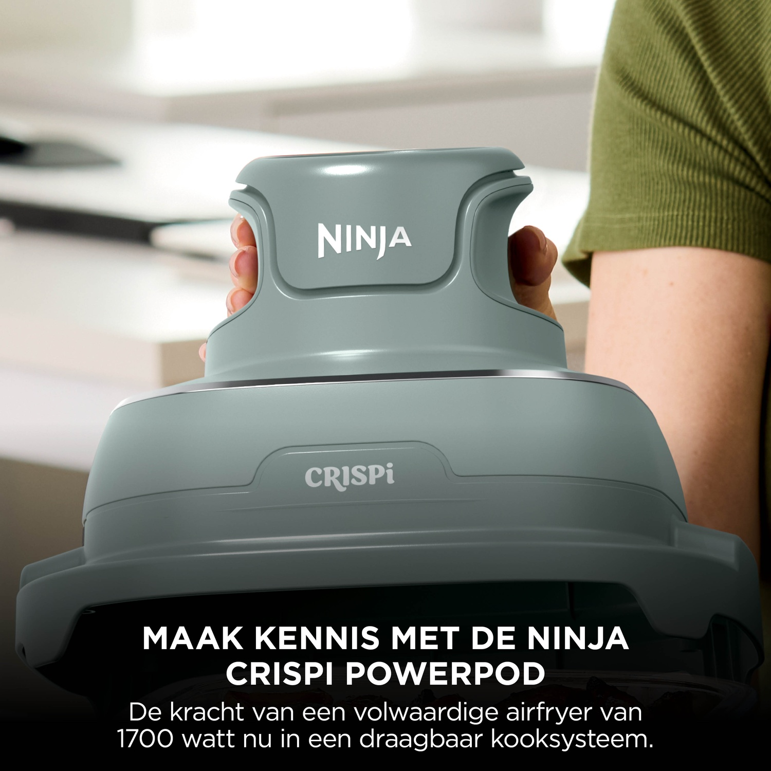 Person holding the grey Ninja Crispi Powerpod cooker