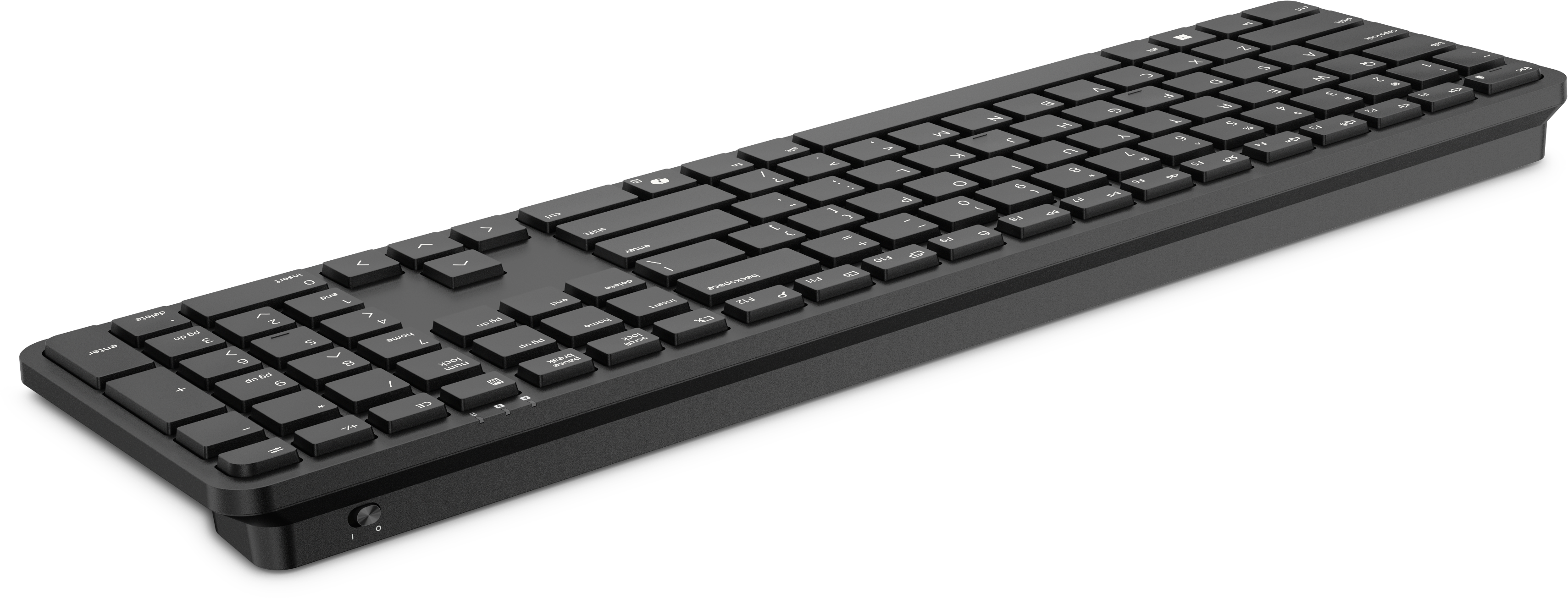 Eine lange schwarze Computertastatur mit weißer Beschriftung auf dunklem Hintergrund.