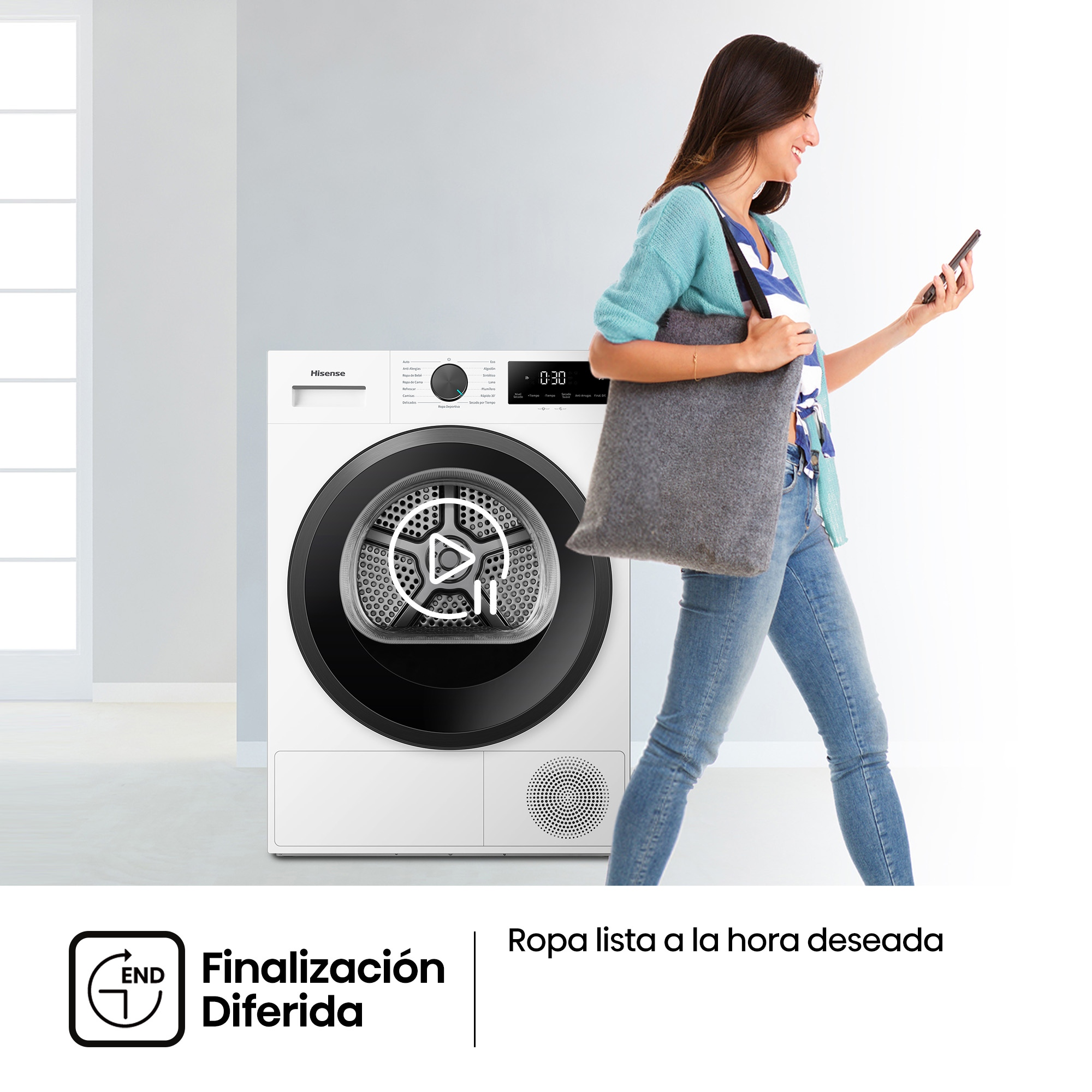 Una mujer con smartphone camina junto a una secadora Hisense.