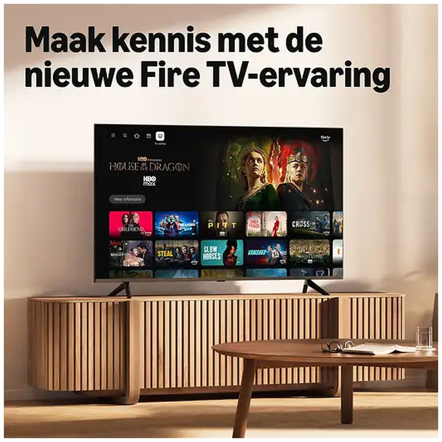 A television on a wooden cabinet displays the Fire TV menu, with text above.