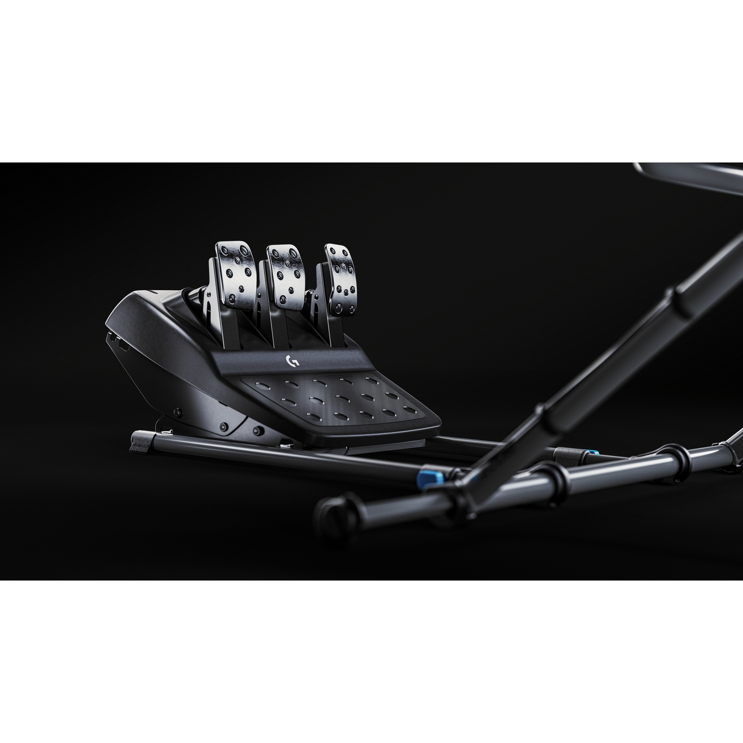Three silver racing pedals on a black base with a metal frame against a dark background.