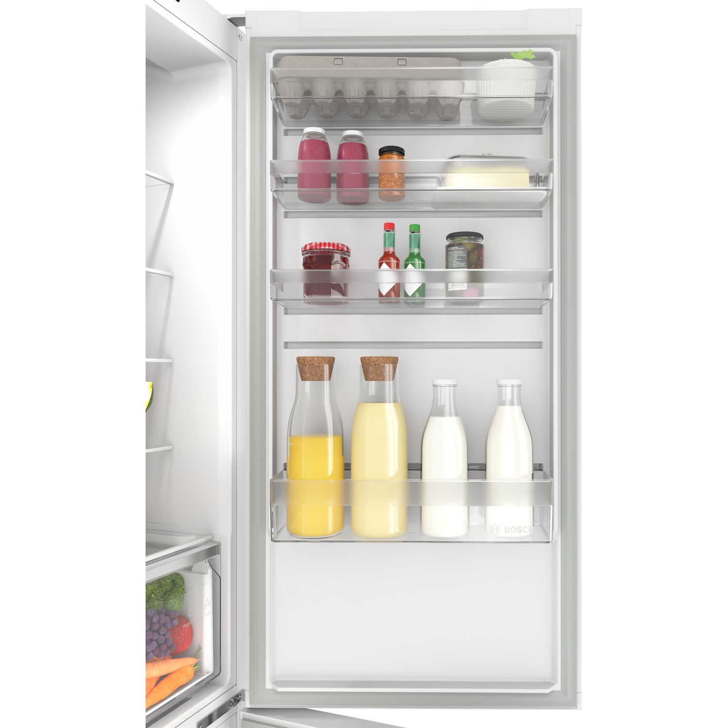 Open white refrigerator door showing shelves stocked with bottles, jars, eggs, and dairy, with produce visible below.