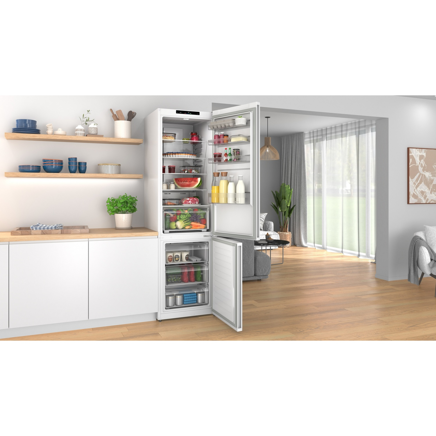 Open white refrigerator in a modern kitchen with stocked shelves and adjacent living room.
