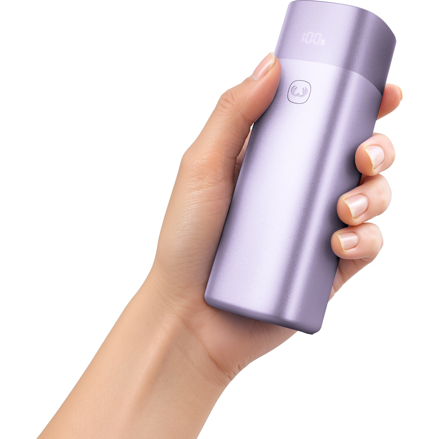 A hand holds an elongated purple power bank with a digital display against a white background.