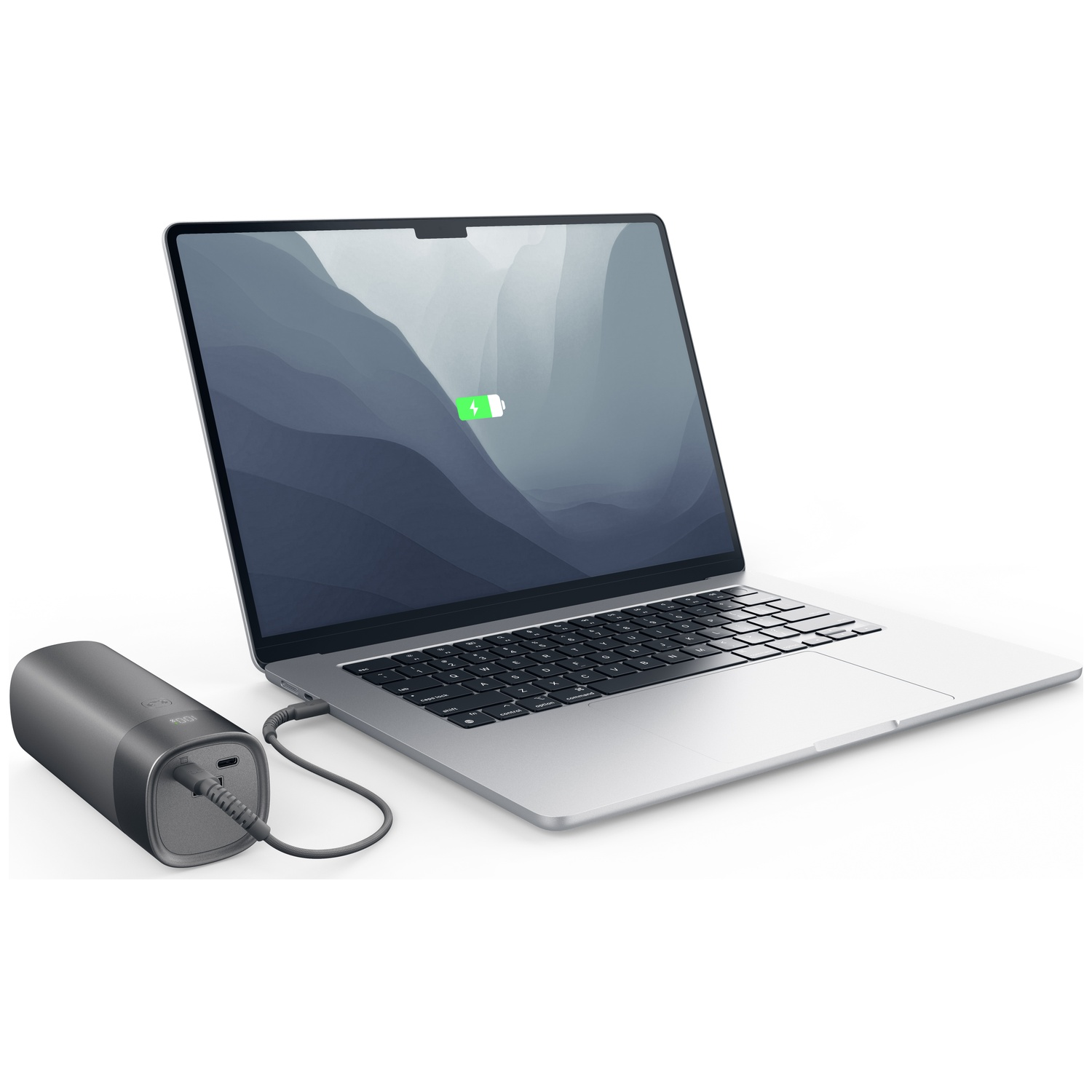 A silver laptop is being charged by a gray power bank on a white background.