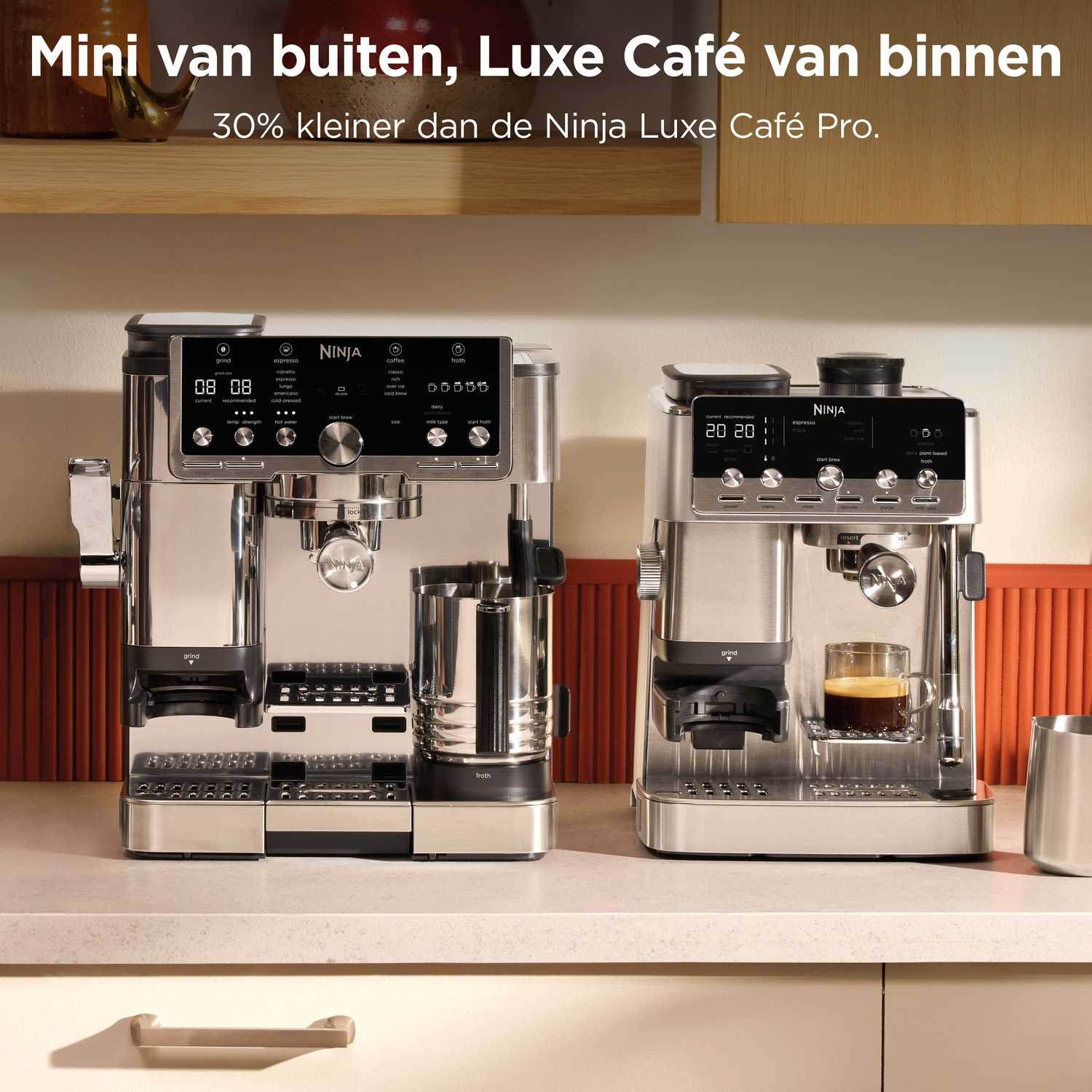 Two silver Ninja coffee machines stand side by side on a kitchen counter.