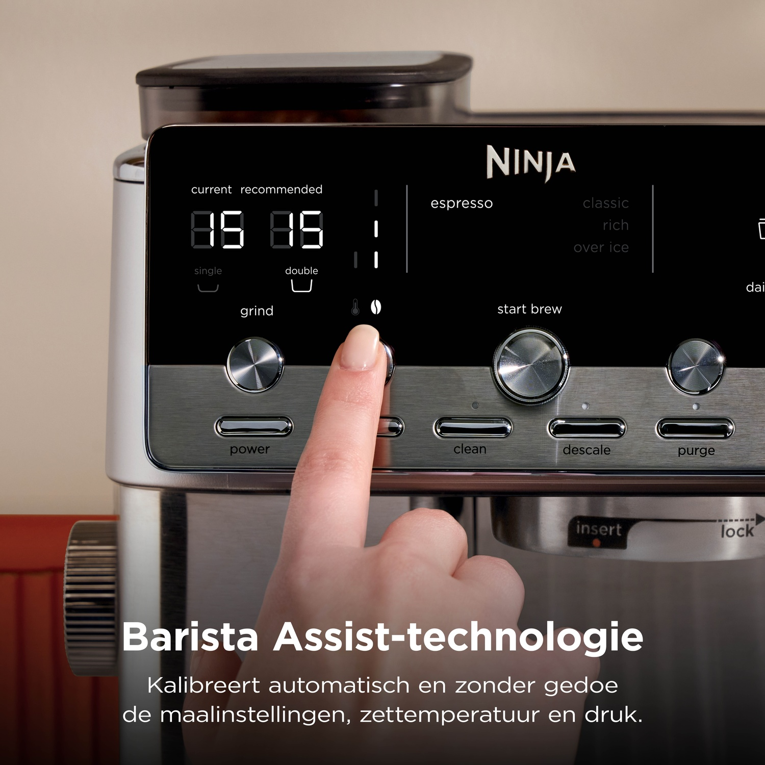 Hand pressing a button on a Ninja espresso machine with Barista Assist technology.