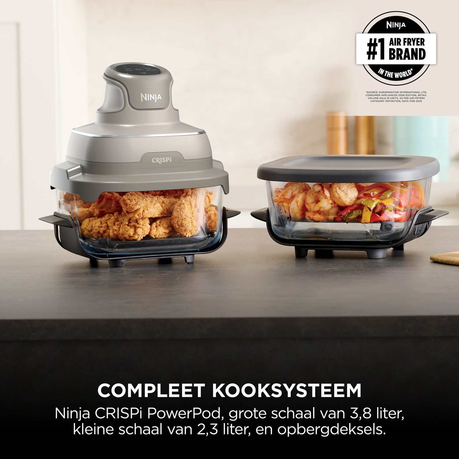 Ninja CRISPi cooking system with PowerPod, two glass bowls holding fried chicken and shrimp on a kitchen counter.