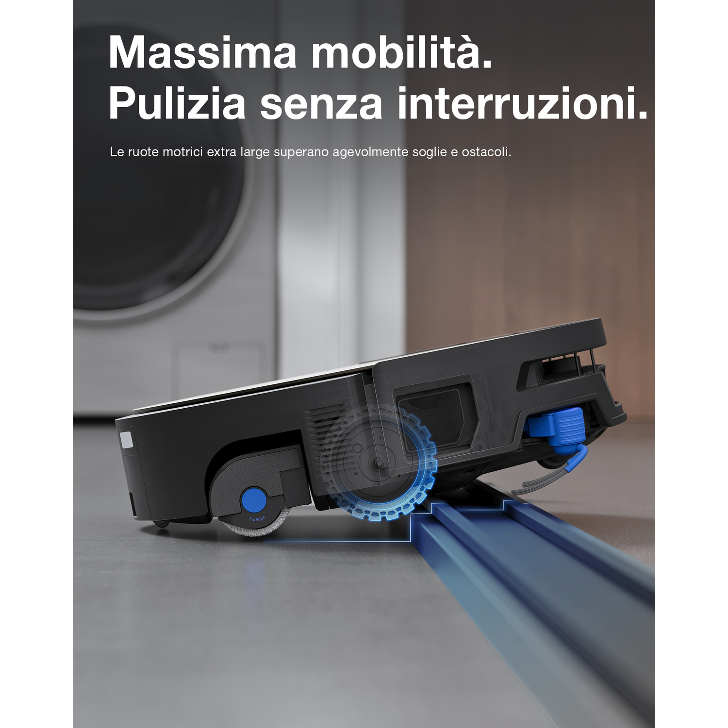 Un robot aspirapolvere nero supera una soglia rialzata su un pavimento liscio.