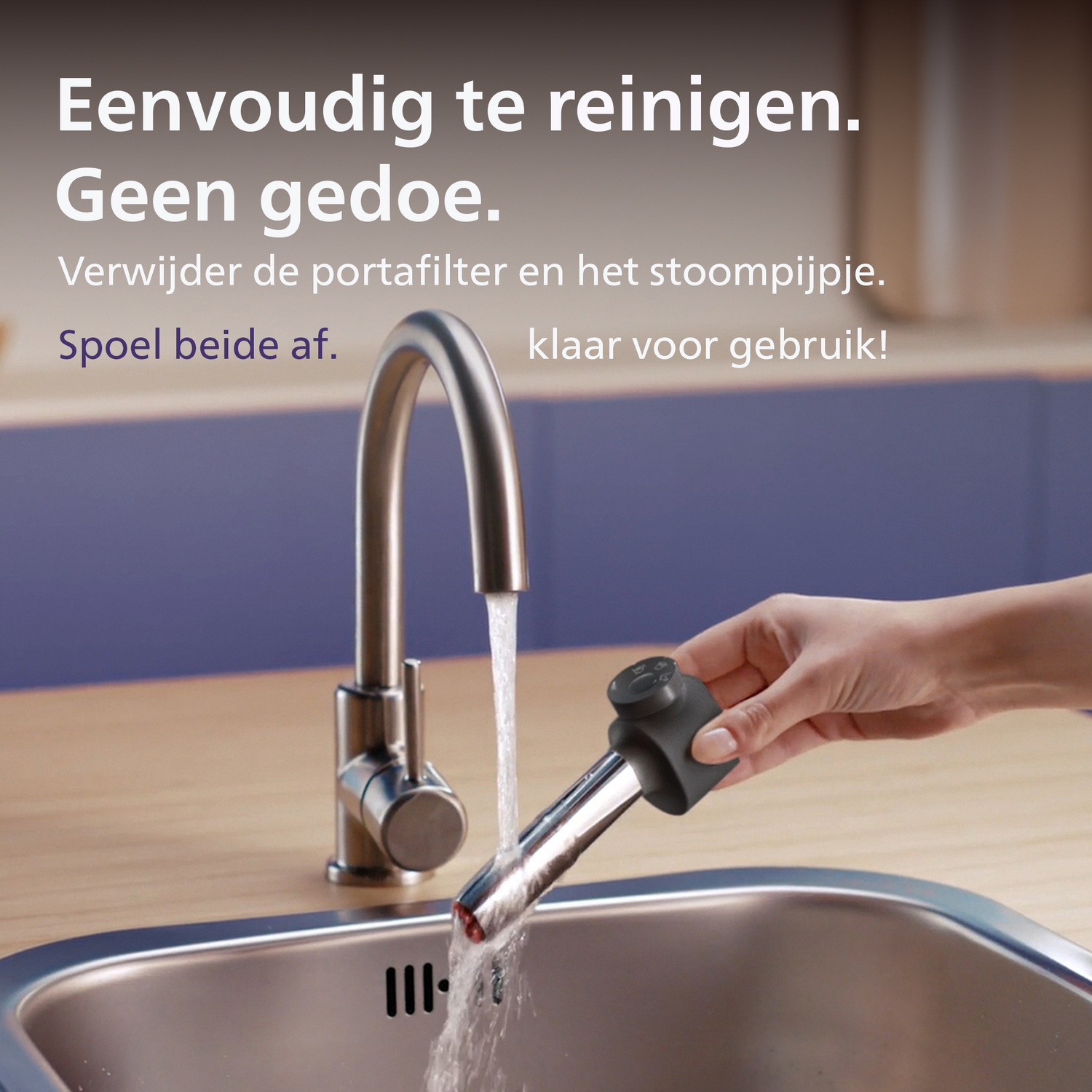 A hand rinses a coffee machine part under running water from a kitchen faucet into a sink.