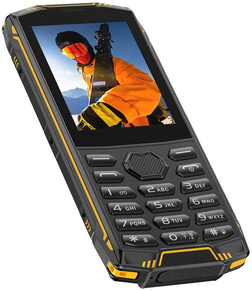 Egy strapabíró, fekete-sárga nyomógombos mobiltelefon, képernyőjén síelővel.