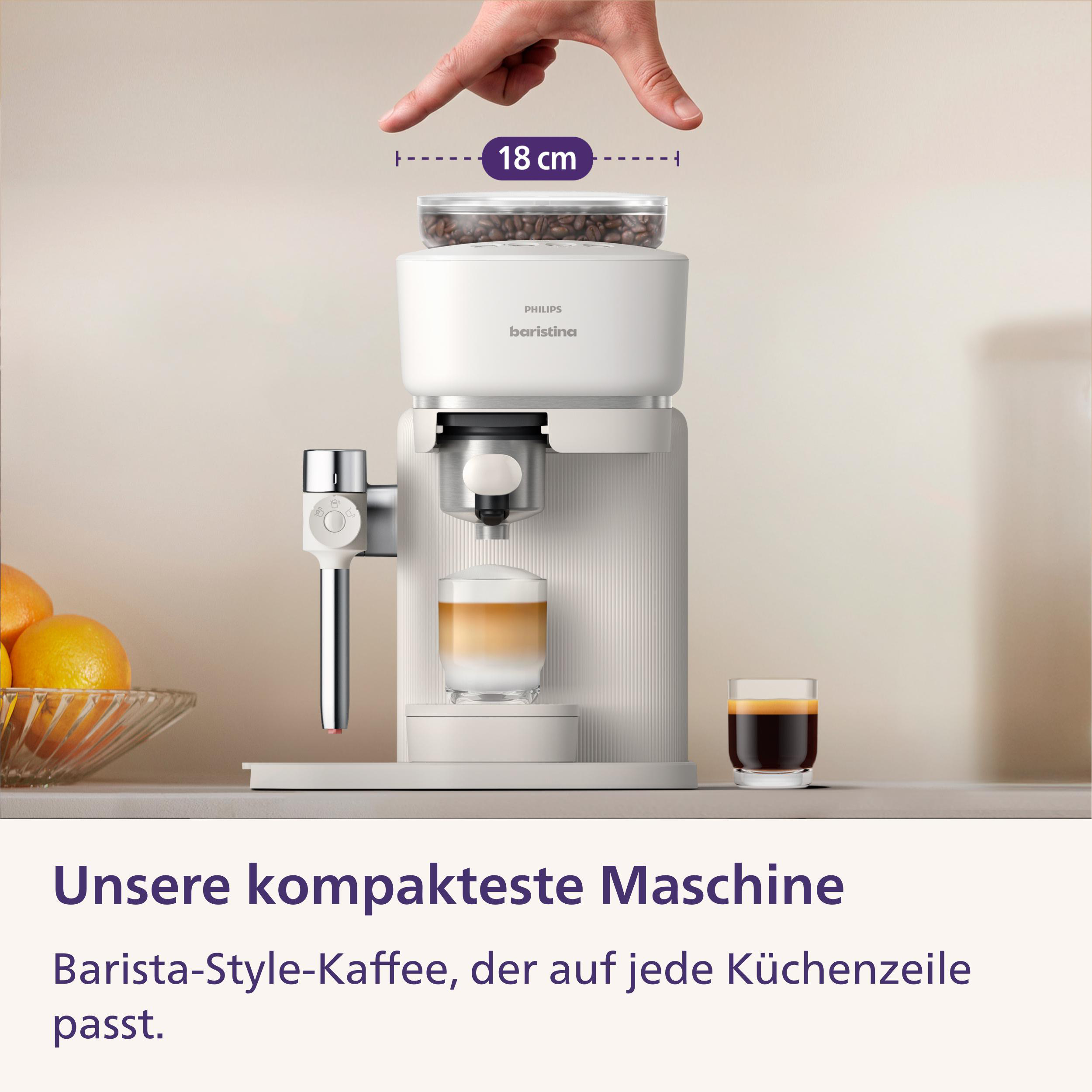 Kompakte weiße Philips Baristina Kaffeemaschine mit 18 cm Breite, Milchschaumglas und Espressoglas auf der Theke.