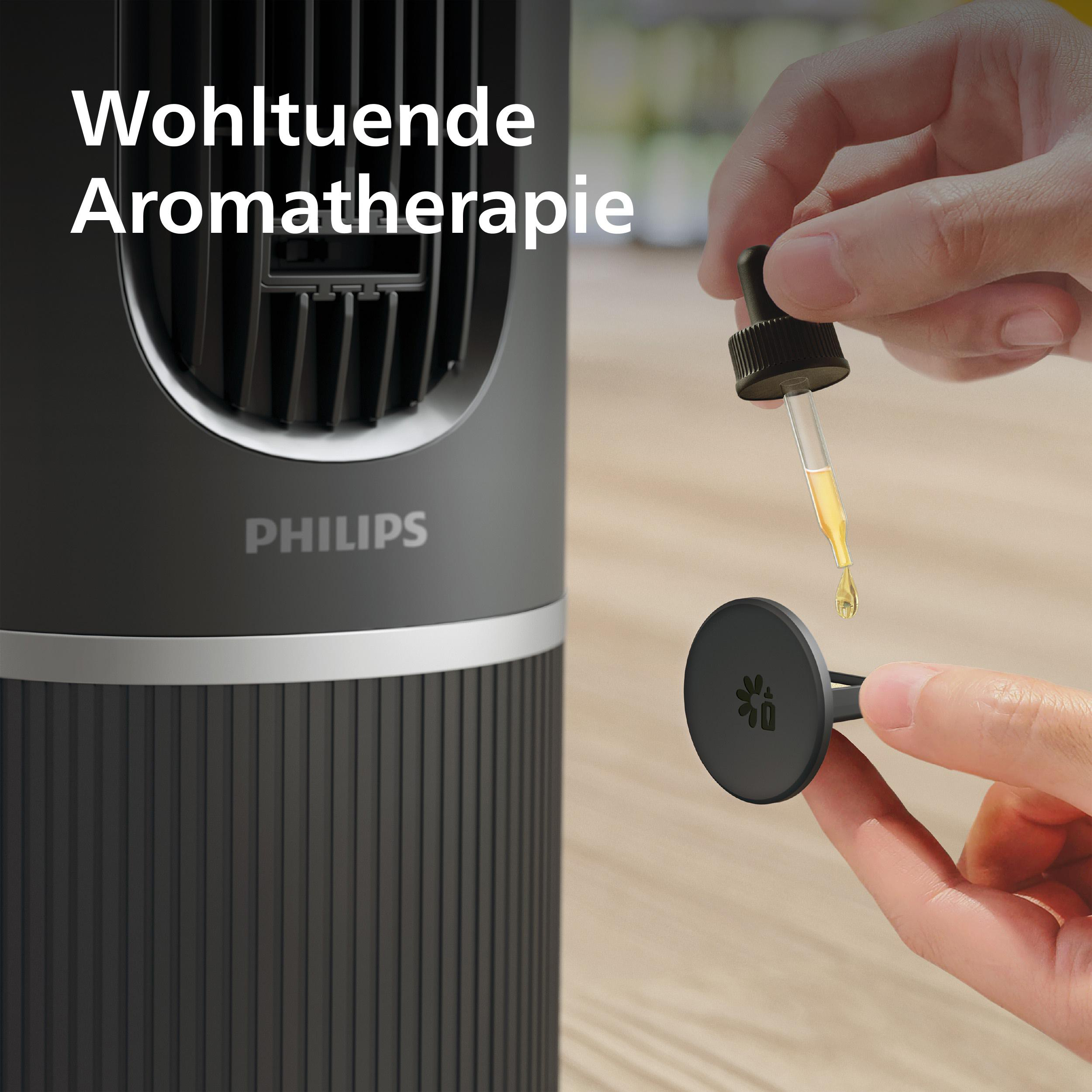 Jemand tropft ätherisches Öl auf das Duftpad eines Philips Geräts.