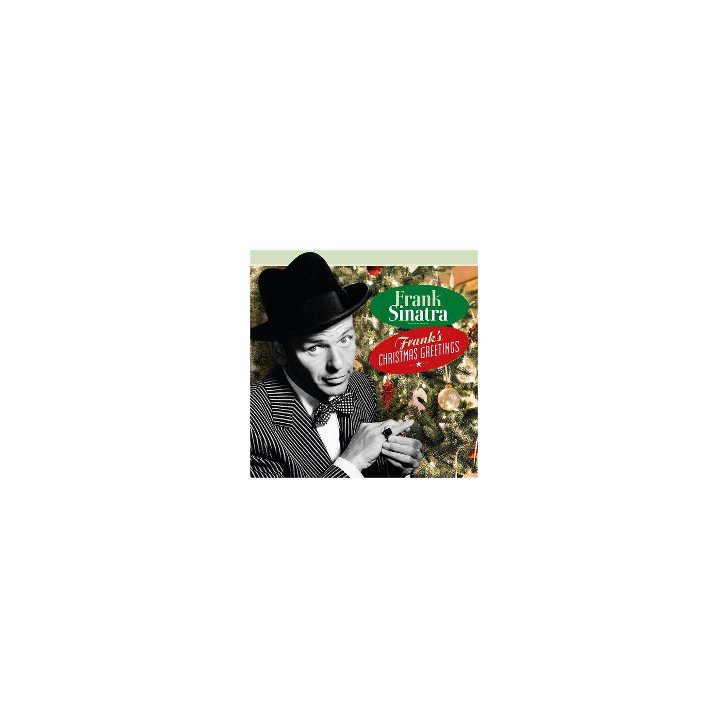 Frank Sinatra met hoed en pak voor een versierde kerstboom.