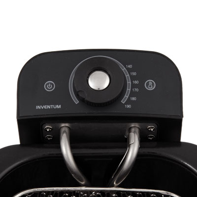 Close-up of an air fryer control panel. The panel has a dial, buttons, and temperature markings.