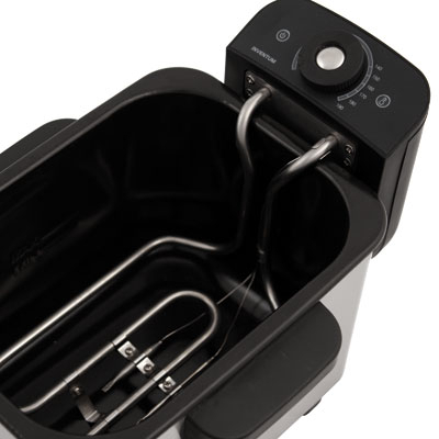 Close-up of a deep fryer with heating elements and temperature controls. Black and silver design.