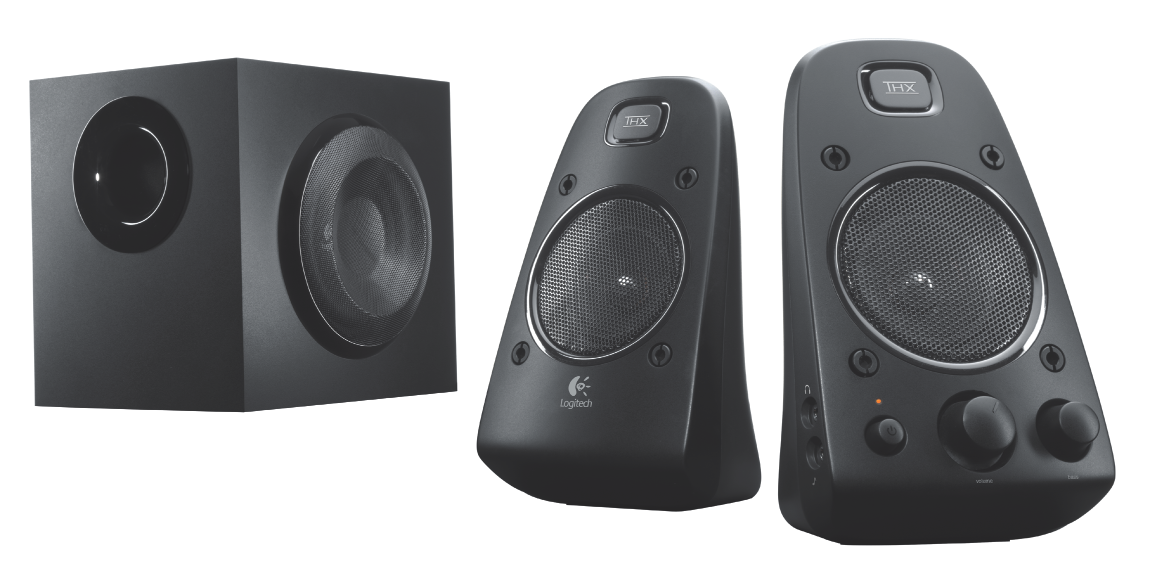 Haut-parleurs et caisson de basses Logitech noirs. Deux haut-parleurs à droite, caisson de basses à gauche. Tous noirs.