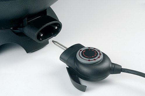 Close-up of an electric appliance plug and its corresponding input.