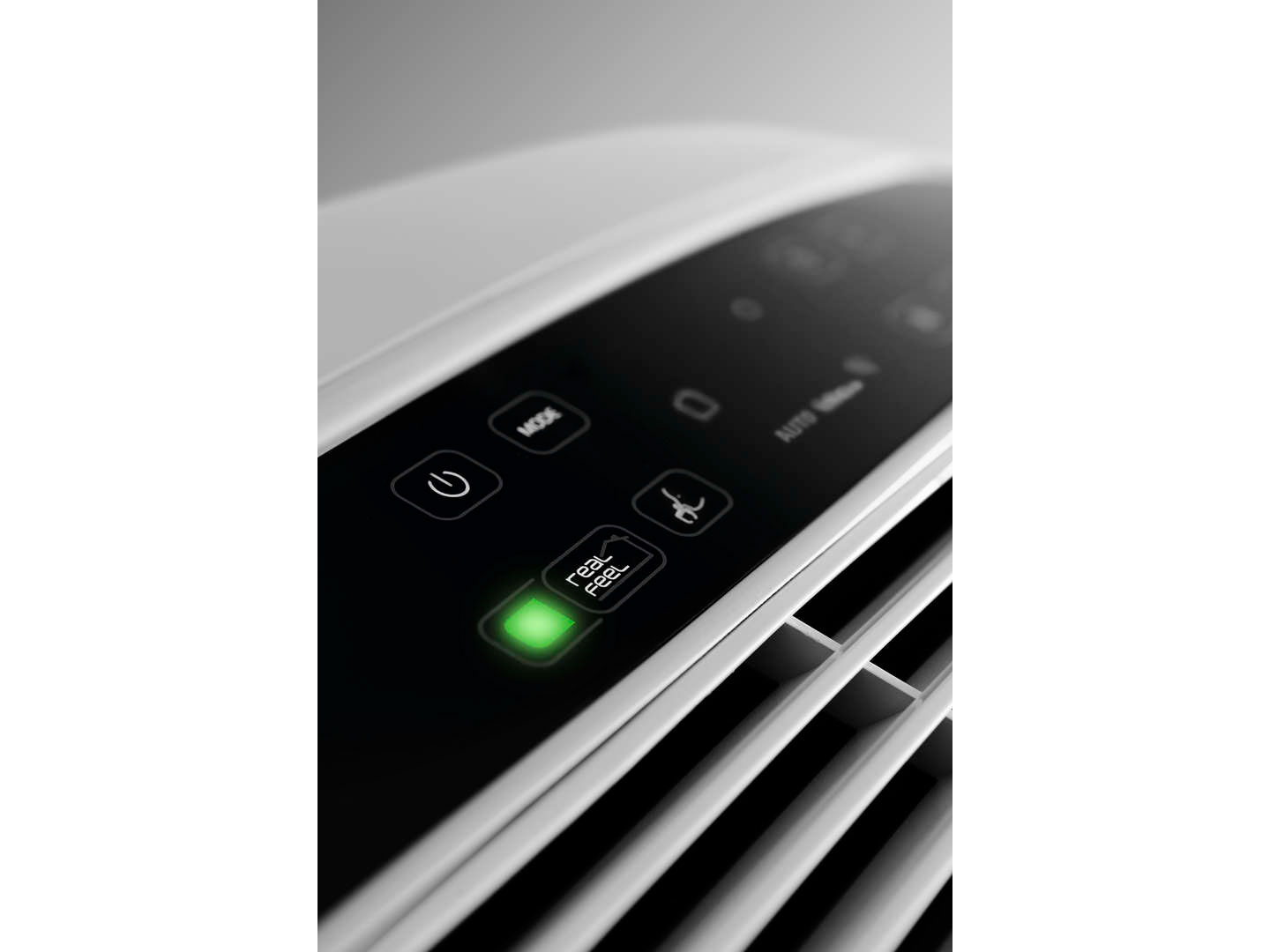 Air purifier control panel with a green Real Feel light on, white fan blades visible below.