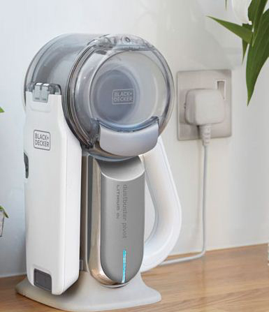 White and gray vacuum cleaner with a charging base and a power plug.