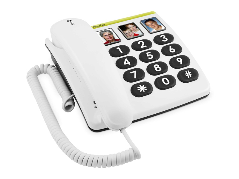White phone with large buttons and a few photos of people on the phone's top.