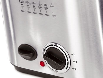 Close-up of a silver deep fryer with black knobs and a red light.