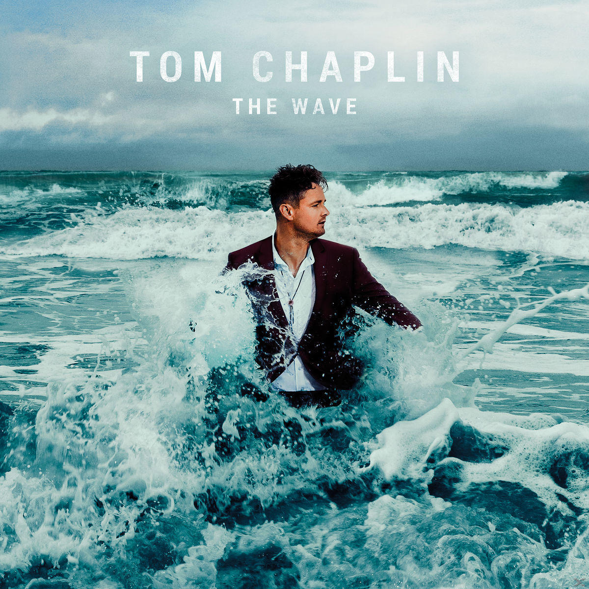 Tom Chaplin dans les vagues, en costume, album 'The Wave'.