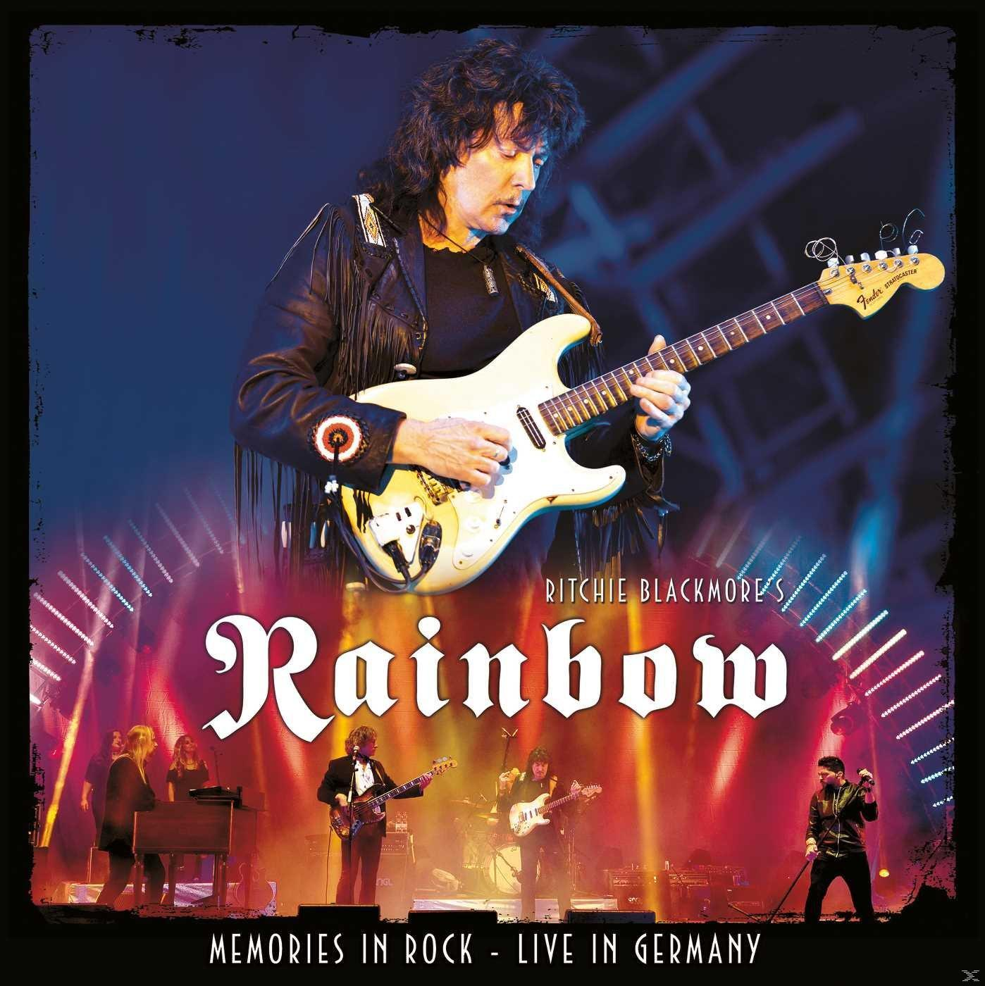 Pochette d'album. Un homme jouant d'une guitare blanche sur scène avec un groupe. Titre : Rainbow, Memories in Rock.