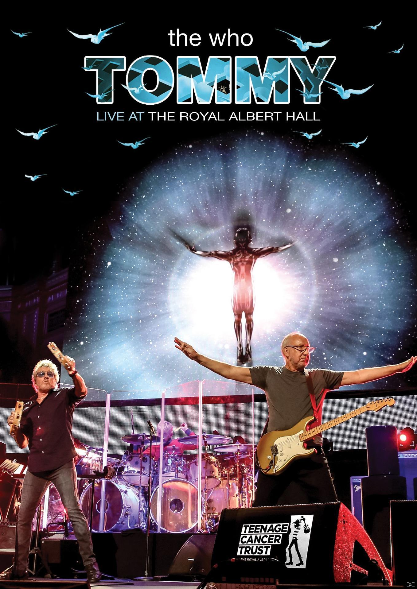 The Who Tommy album cover. Two men on stage, band in background, and a figure on a stage.