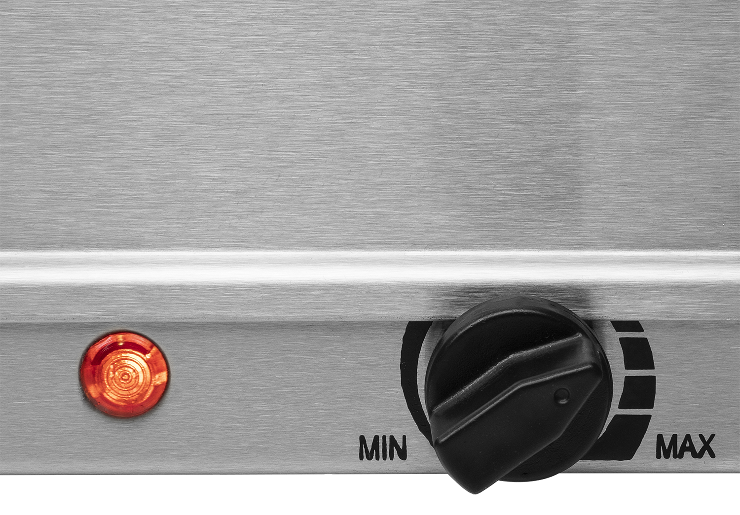 Close-up of a stainless steel surface with a knob and a light.