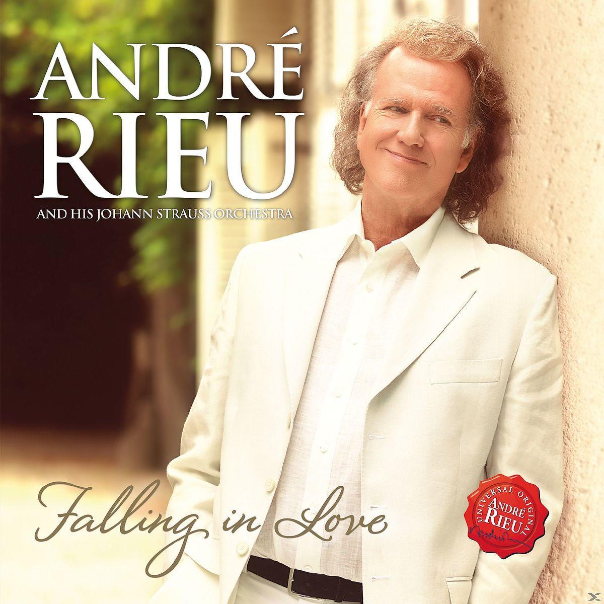 André Rieu album borítója, fehér öltönyben, mosolyog. A szöveg 'Falling in Love' és 'André Rieu'.