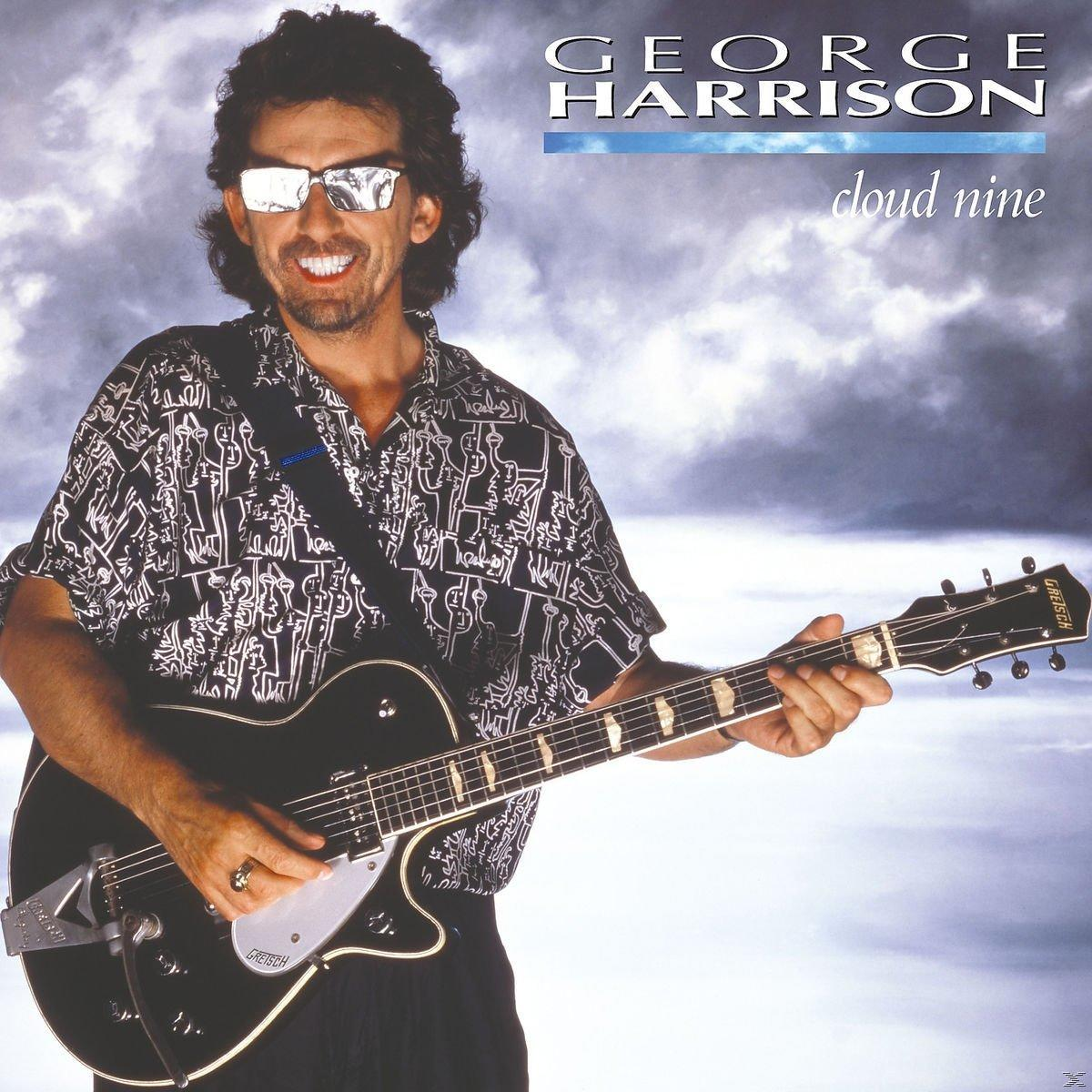 Pochette de l'album de George Harrison. Harrison tient une guitare noire et porte des lunettes de soleil et une chemise à motifs.