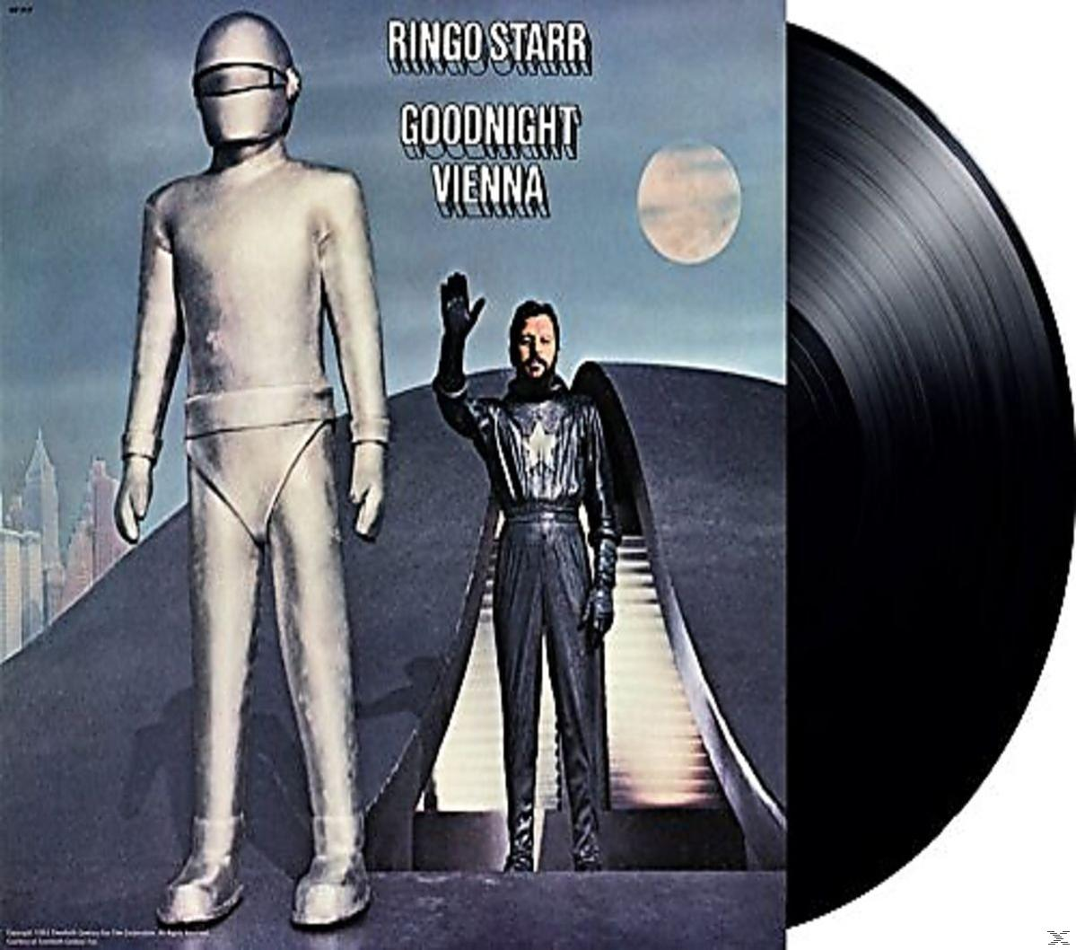 Pochette d'album : Ringo Starr avec un robot et une ville futuriste. Disque vinyle à droite. Fond sombre.