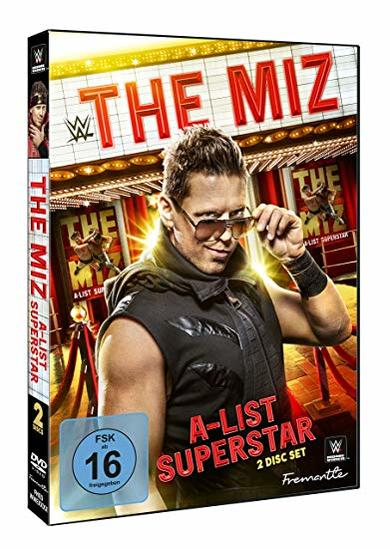 DVD-Cover mit einem Mann mit Brille, der seine Brille hält, auf rotem Teppich.