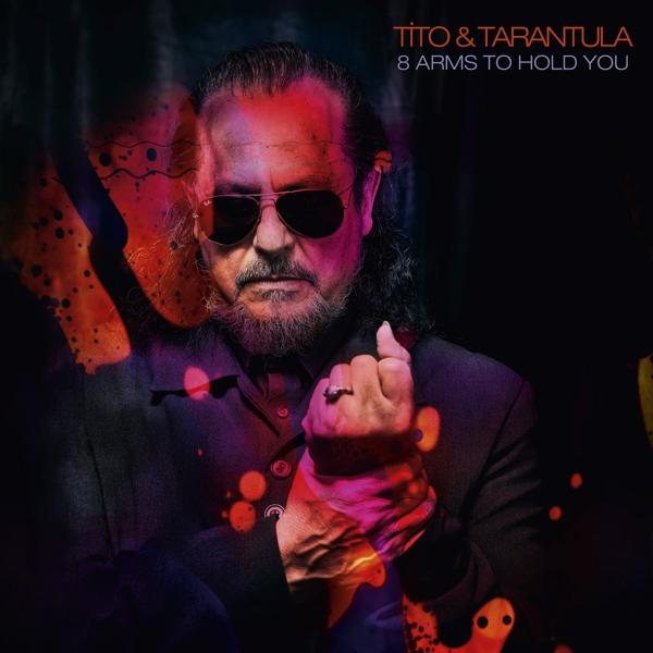 Tito & Tarantula Albumcover. Mann mit Sonnenbrille und Bart. Text: '8 Arms To Hold You'. Dunkler Hintergrund.