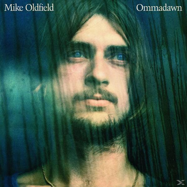 Albumcover: Mike Oldfield mit langen Haaren, der den Betrachter ansieht. Blauer und grüner Hintergrund.