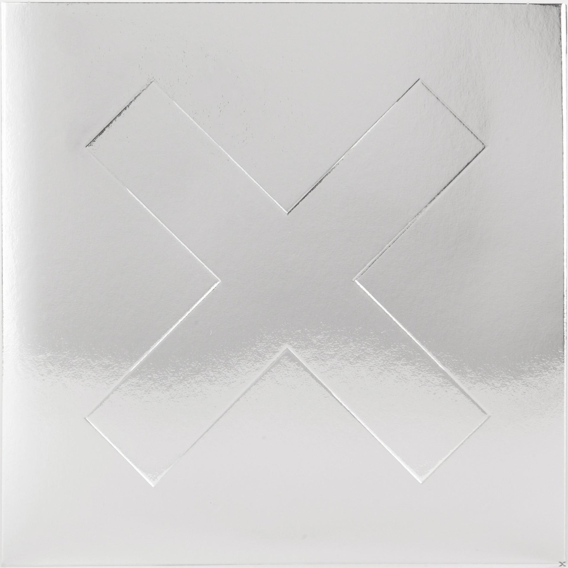 Albumcover: Silbernes Quadrat mit einem X-förmigen Prägedruck in der Mitte.