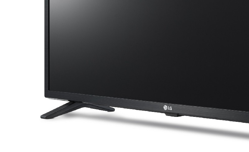 Un televisor LG negro con un soporte negro, sobre un fondo blanco, mostrando una pantalla negra.