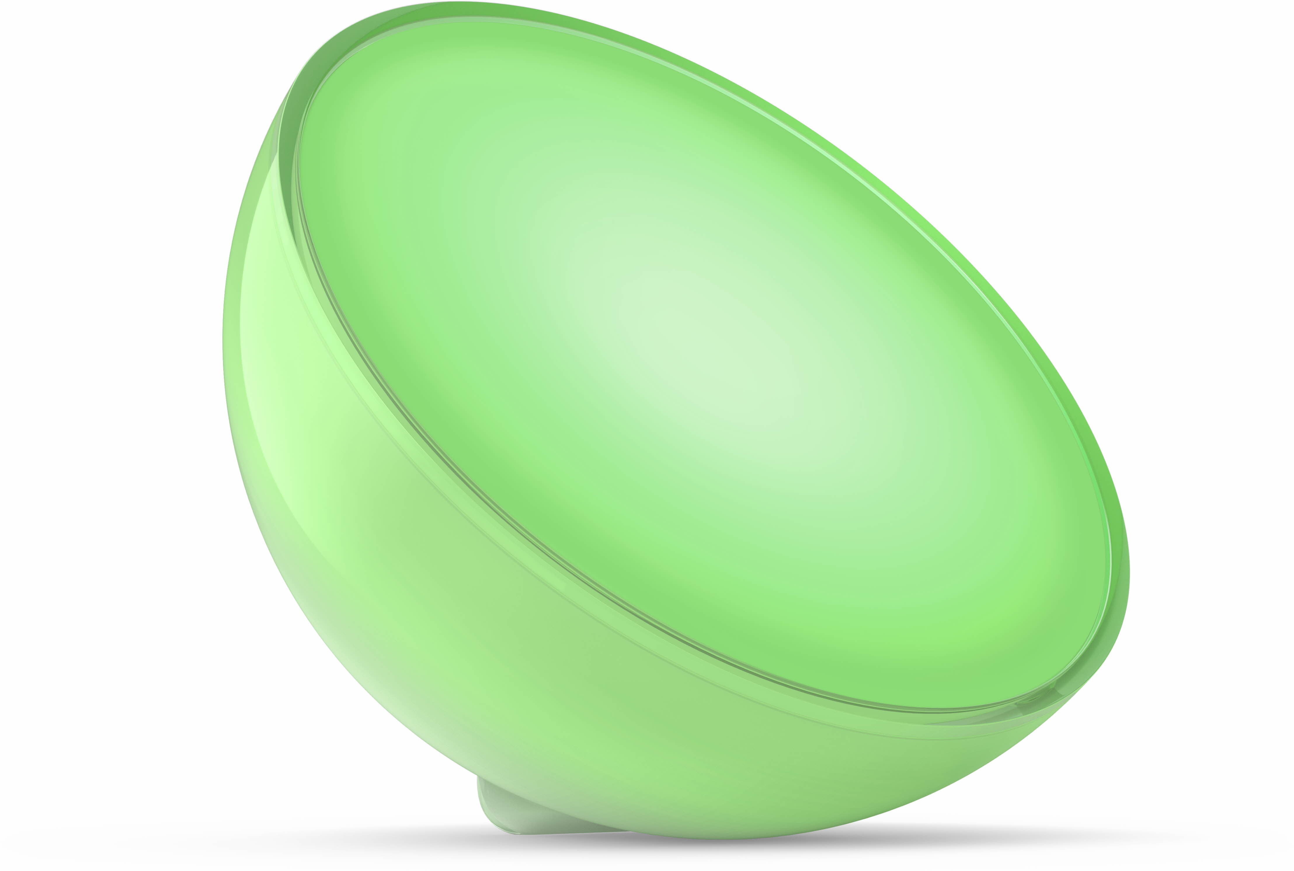 Lumière verte Philips Hue Go. Une forme arrondie en demi-sphère, brillant en vert, sur fond blanc.