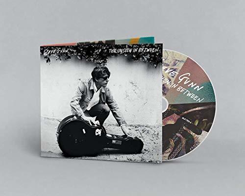 Albumcover mit einem Mann, der einen Gitarrenkoffer auf den Boden stellt.