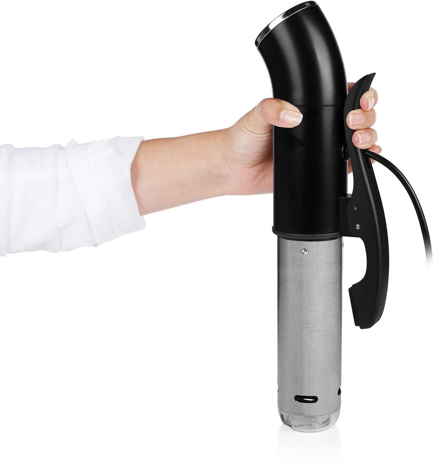 Hand holding a black and silver immersion circulator. A white shirt sleeve is visible.