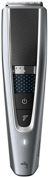 Silver beard trimmer. It has a cutting head, adjustment settings, and a power button.