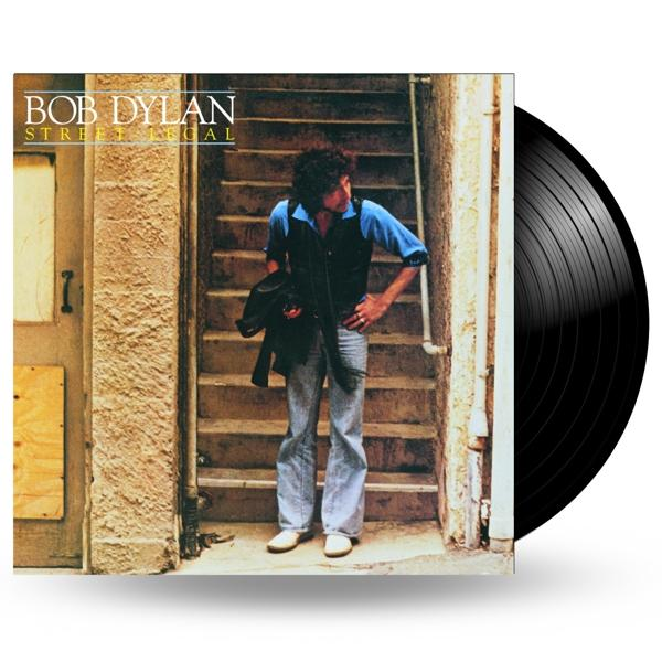 Schwarze Schallplatte und Albumcover. Bob Dylan steht auf einer Treppe mit einer Tür und einer Wand im Hintergrund.