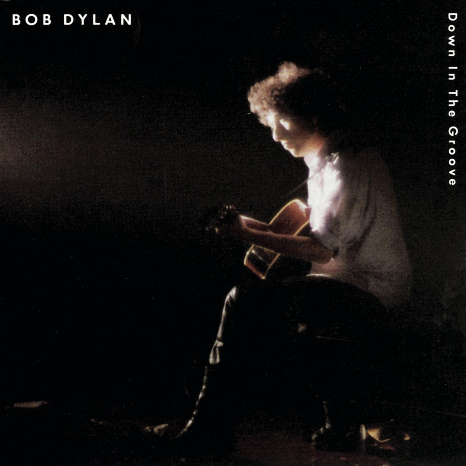 Bob Dylan Albumcover, Mann mit Gitarre, dunkler Hintergrund.