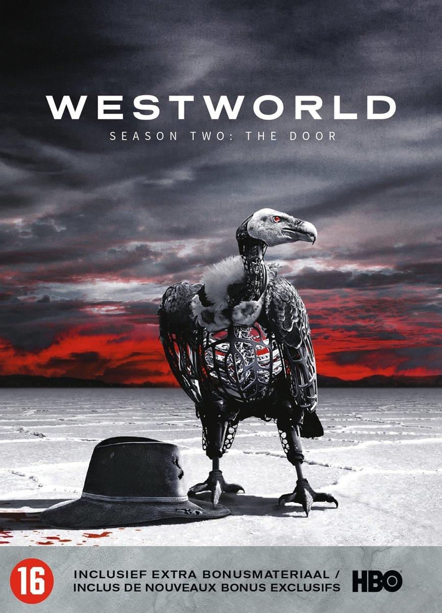 Westworld DVD cover with a vulture and a hat on a sandy surface.