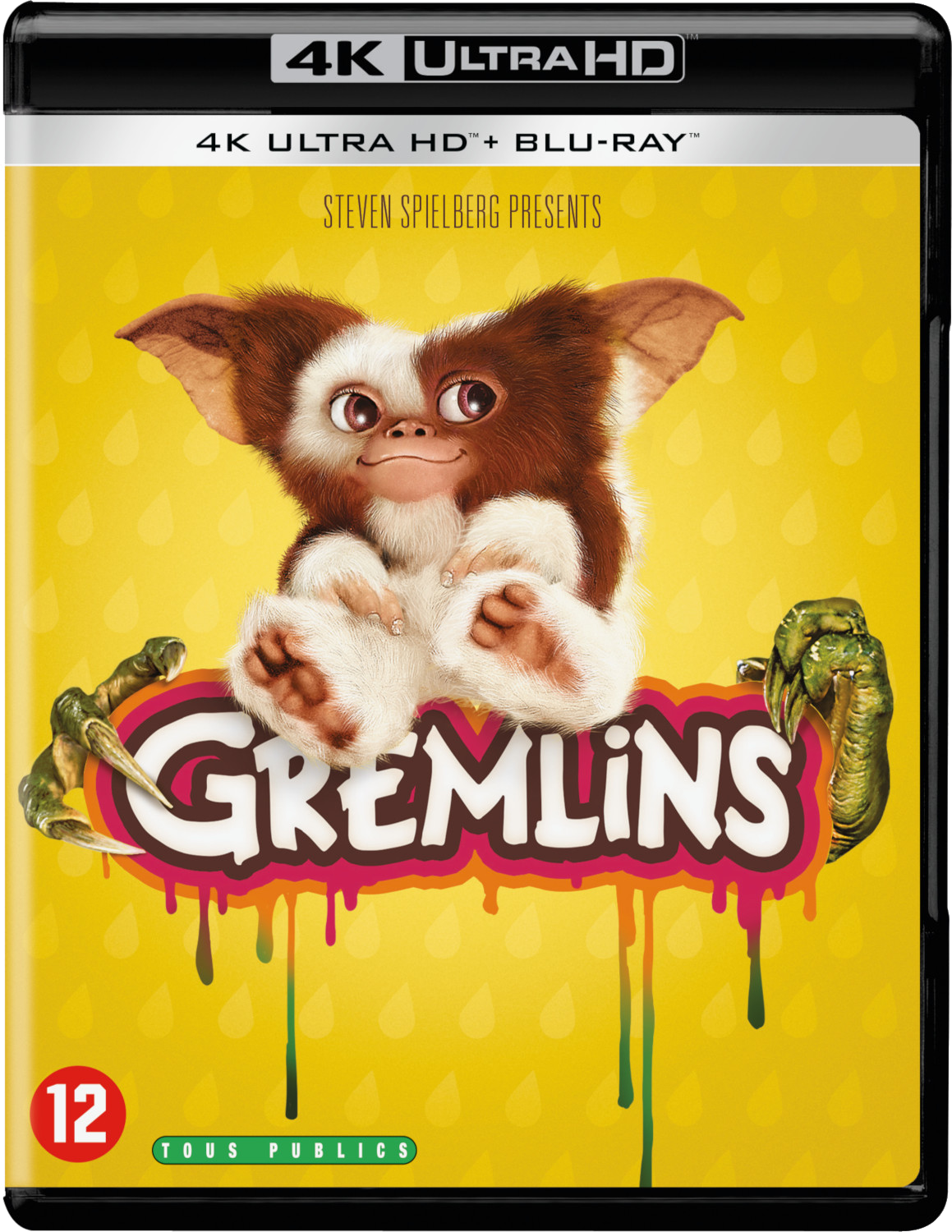 Couverture Blu-ray de Gremlins. Un Mogwai est assis sur le logo du titre. Fond jaune.