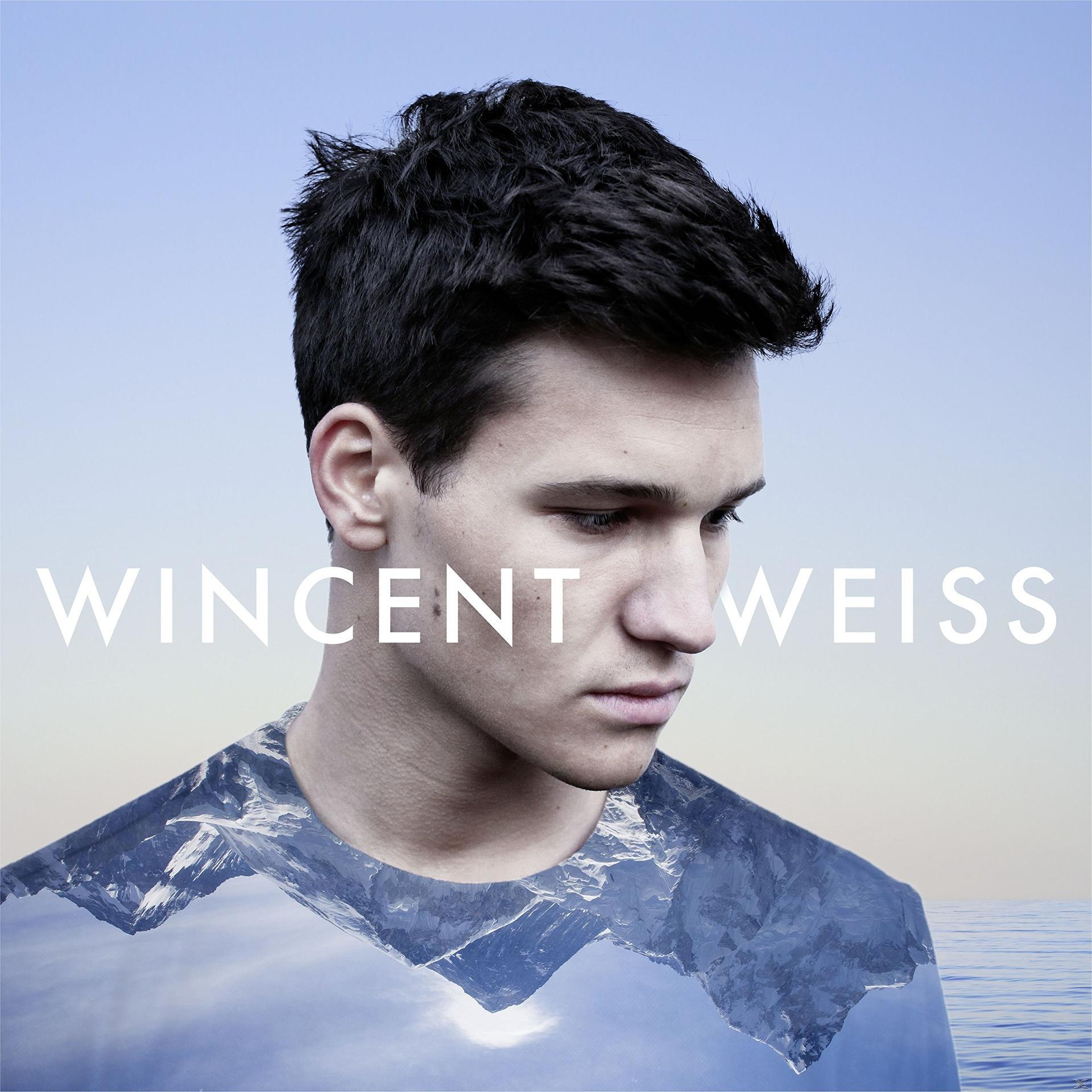 Albumcover: Ein Mann mit dunklen Haaren und einem Gebirge im Hintergrund.