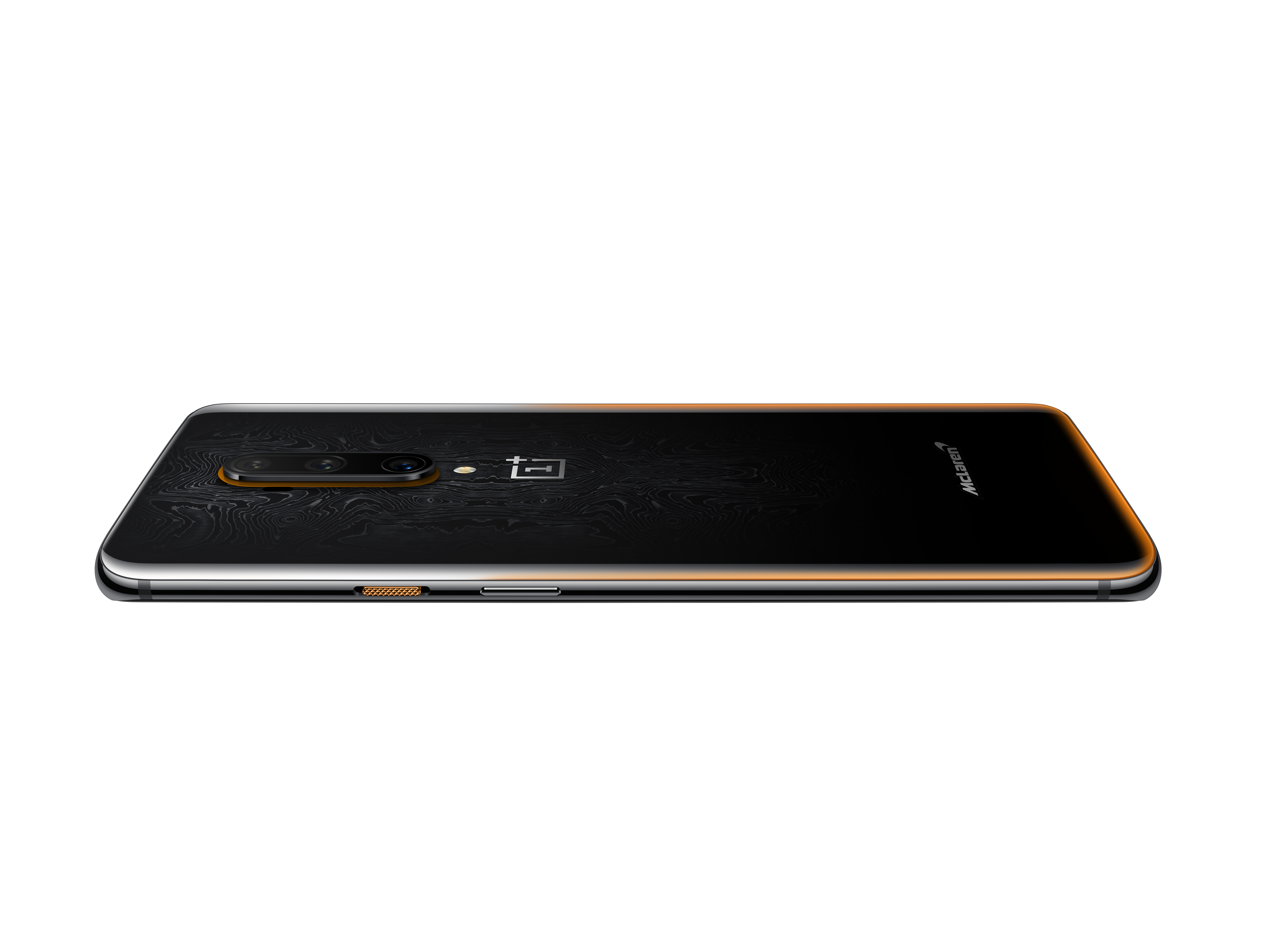 Teléfono negro con borde dorado, mostrando la parte trasera. Logo OnePlus visible.