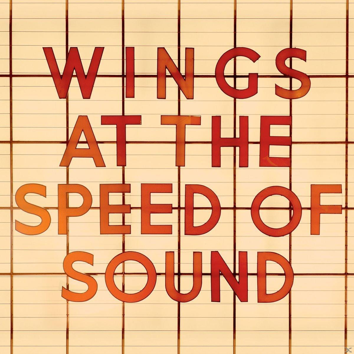 Albumcover. Roter Text auf beigem Raster: Wings at the Speed of Sound.